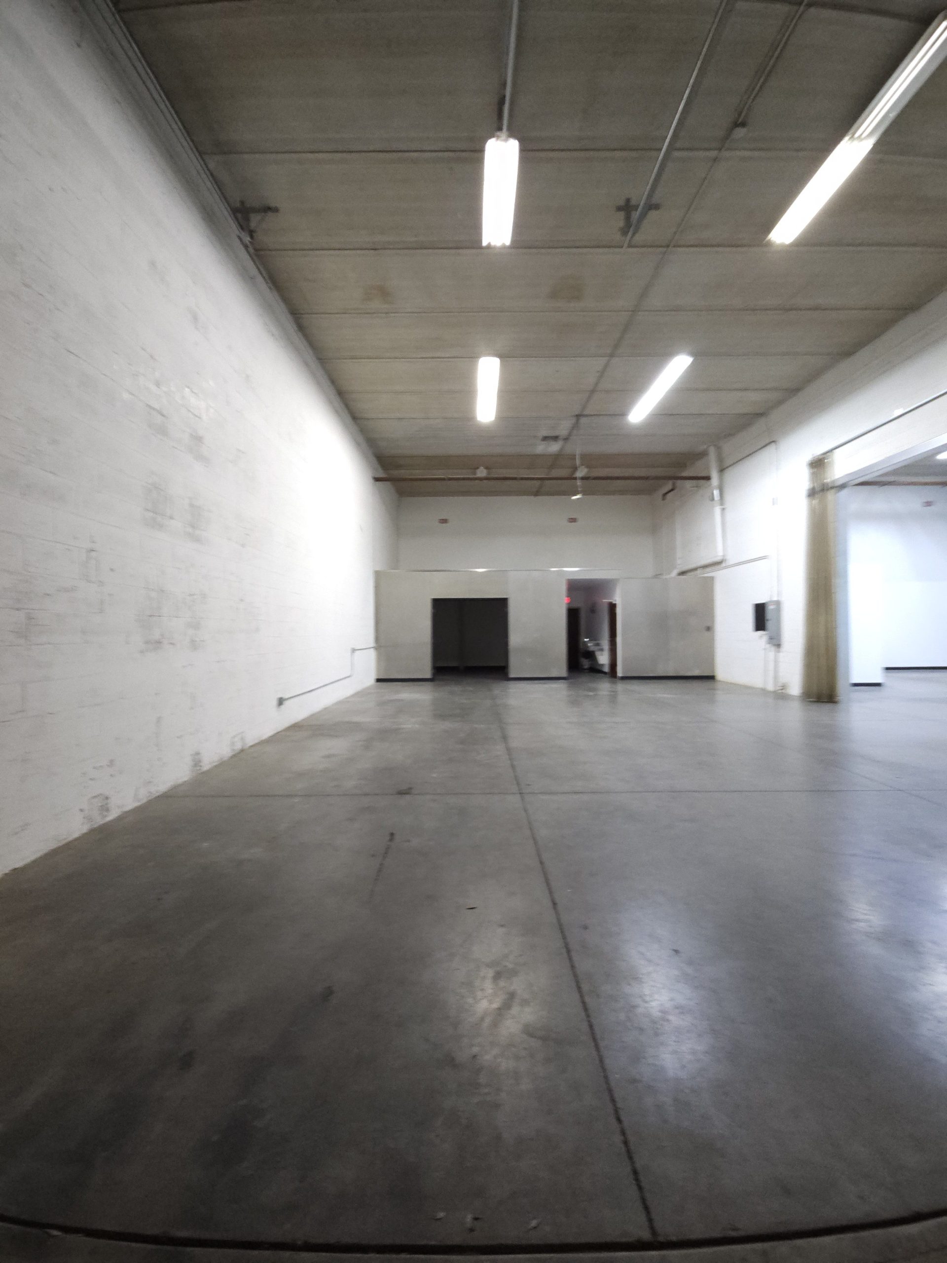 Empty industrial warehouse with a freshly cleaned concrete floor